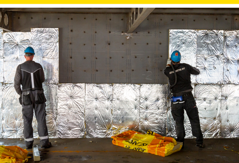 Men insulating a ship