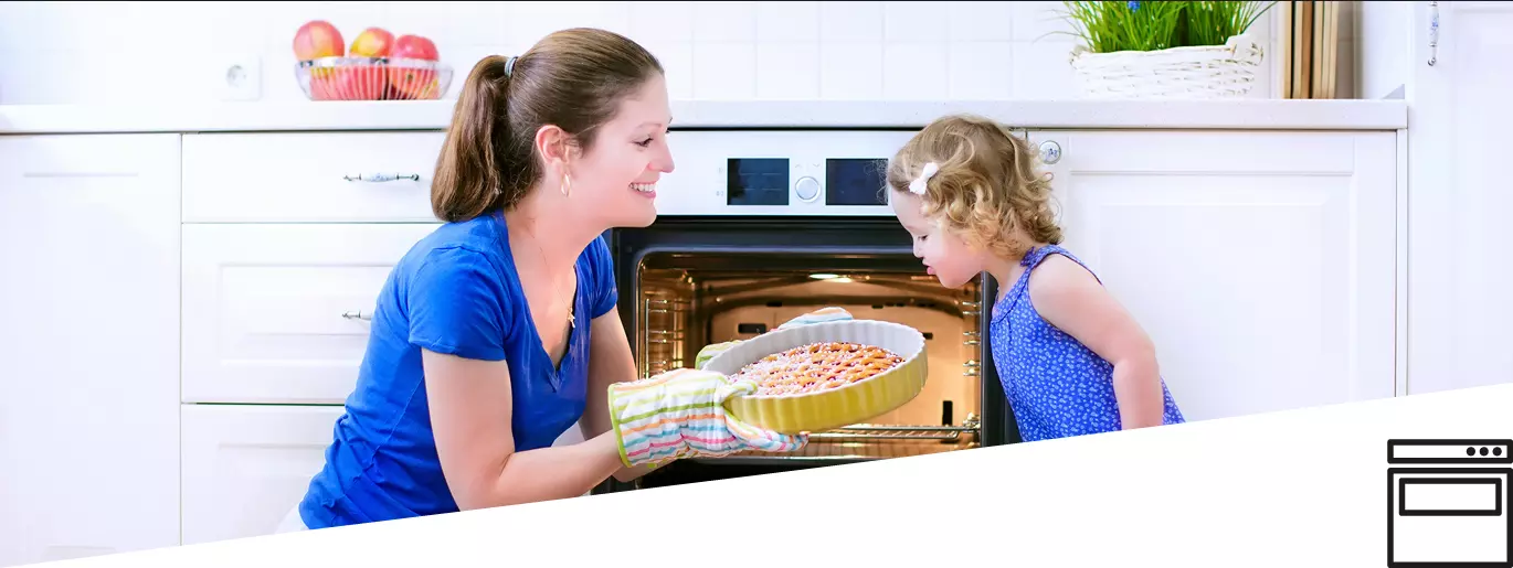 Mother and daugther next to oven